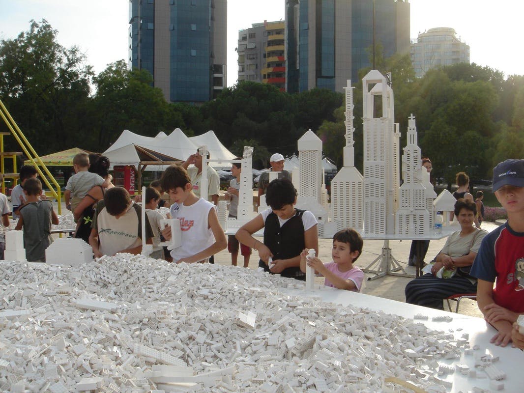 A group of people building structures out of Lego in Olafur Eliasson's art piece, “The Collectivity Project”.